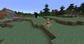 A villager in a minecart in a boat near a portal.