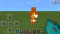 A burning zombie ในรุ่น Bedrock emitting unique fire particles.