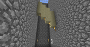 A finished airlock. Pressing the button triggers a , which removes the torch placed on the cobblestone, letting the sand fall.