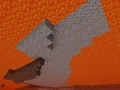 Gravel hanging above the lava sea, without any support below. Viewed in Spectator mode.