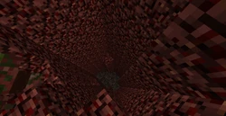Een gat naar bodemsteen in de Nether.