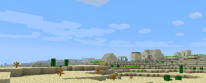 Изображена пустыня с деревней NPC из песчаника на фоне.