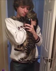 Karl hugging his cat.