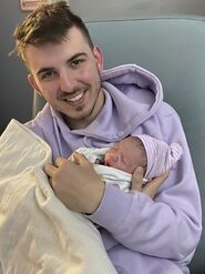 Chris Holding Newborn Tucker