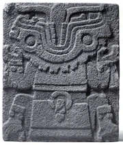 La cabeza de Tlatlecuhtli se muestra movida hacia atrás con una lengua de serpiente y un cuchillo de sacrificio entre sus dientes.