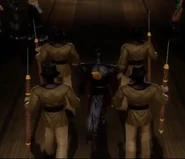 Four Masked Guards escort Ermac as he is introduced.