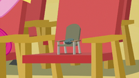 Boulder sitting in a tiny chair S7E4