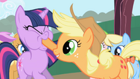 Applejack forcing Twilight to taste an apple S01E01