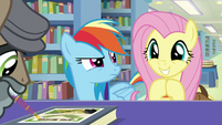 Rainbow looks at grinning Fluttershy S9E21