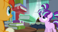 Filly Starlight levitates book out; looks up at book tower S5E26
