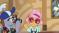 Tourist ponies taking pictures of resort S6E20