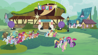 Ponies gathered outside the bowling alley S5E9