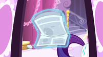 Rarity walks away from the entrance with the newspaper S6E9