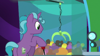 Hotel pony playing a claw machine game S8E5