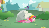 Pinkie Pie taking cover underneath a rock.