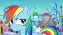 Rainbow looking at the hotel behind her S8E5