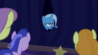 Trixie appears annoyed from behind the curtain S6E6