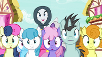 Cloaked Rarity appears over crowd of ponies S7E19