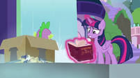 Twilight frantically opens the book S9E5