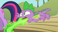 Spike firing up a letter from Princess Celestia.