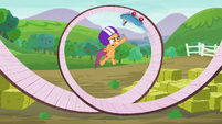 Scootaloo jumps while the scooter scoots on a circular track S6E4