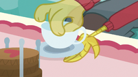 Discord placing teacup on a small plate S7E12