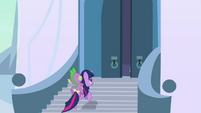 Twilight running up the stairs with Spike on her back.