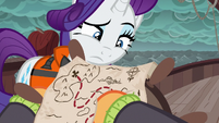 Applejack points at Plunder Cove on the map S6E22