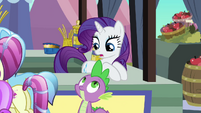 Spike and Rarity look at each other.