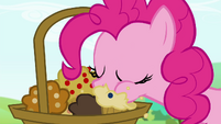 Pinkie Pie taking a bite off of one of the muffins S4E18