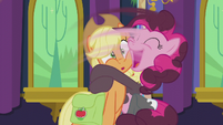 Pinkie swoops Applejack into a hug S5E20