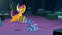 Smolder putting tree pieces in a pile S9E3