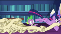 Twilight leaving the library with a long scroll S7E1