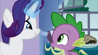 Spike, looking at Rarity, eating the pie.