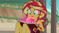 Sunset looking at her glowing journal pages EGFF