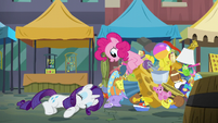 Pinkie Pie pops out of the pile of toys S6E3