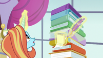 Sassy Saddles looking at her stack of binders S7E6