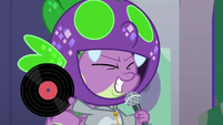 Spike holding up a vinyl record S9E7