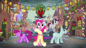 The Spirit of Hearth's Warming Presents standing in front of the town's water fountain S06E08