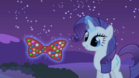 Rarity holding a bow with her magic S1E24