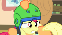 Apple Bloom being put on a second helmet S4E17