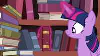 Twilight in front of bookshelf S4E09