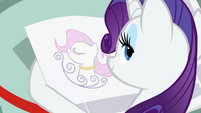 Rarity looking at a news ad S2E23