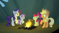 Rainbow Dash tosses a campfire into the cave S7E16