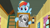 Rainbow smiling with picture of herself S8E20