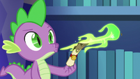 Spike blowing fire on yet another scroll S6E15