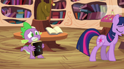 Spike holding Star Swirl's book S03E13