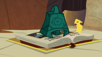 Bewitching Bell rests on the spell book S9E24