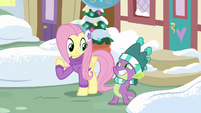 Spike grinning innocently at Fluttershy MLPBGE