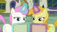 Twinkleshine and unicorn mare look at Tasty Treat flyer S6E12